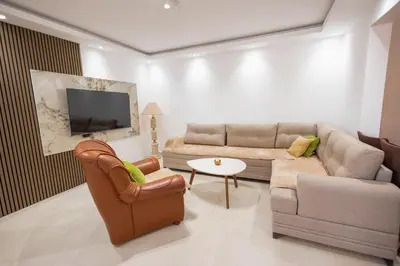 a living room with a couch and a tv at Montanica in Virpazar