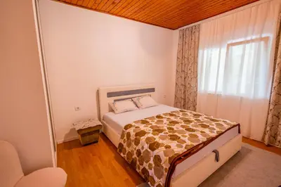 a small bedroom with a bed and a window at Montanica in Virpazar