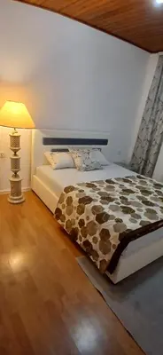 a bedroom with a bed and a lamp at Montanica in Virpazar