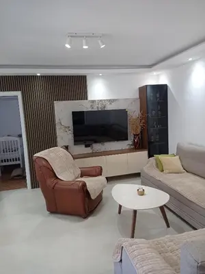 a living room with a couch and a tv at Montanica in Virpazar