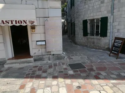 a sign on the side of a building at Square view in Kotor