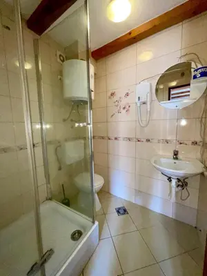 a bathroom with a shower and a sink and a toilet at bella 11 in Kotor