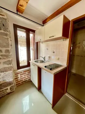 a small kitchen with a sink and a window at bella 11 in Kotor