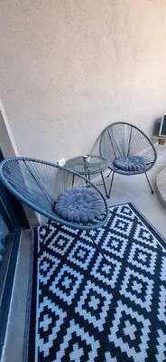 a room with two chairs and a table and a rug at Harmoniya apartment in Bar