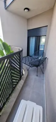 a balcony with a bench and a chair on it at Harmoniya apartment in Bar