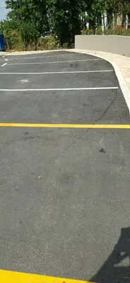 an empty parking lot with yellow and white at Harmoniya apartment in Bar