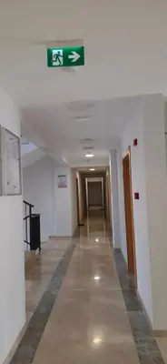 a hallway in a building with a sign on the ceiling at Harmoniya apartment in Bar