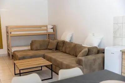 a living room with a couch and a bunk bed at Vila Luxembourg in Ulcinj