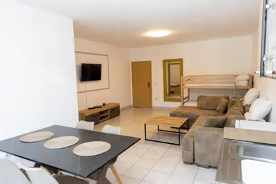 a living room with a couch and a table at Vila Luxembourg in Ulcinj