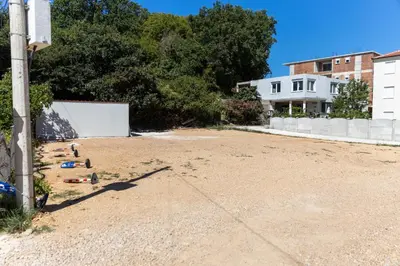 an empty parking lot with people laying on the ground at Vila Luxembourg in Ulcinj