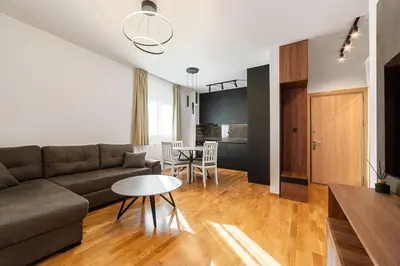 a living room with a couch and a table at Aurora 2 Apartment with Garage in Budva