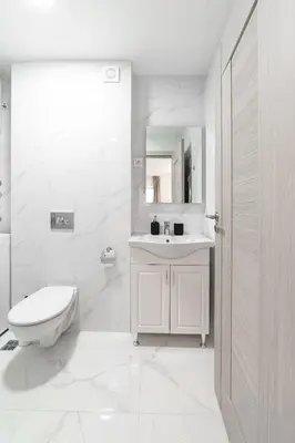 a white bathroom with a toilet and a sink at Aurora 2 Apartment with Garage in Budva