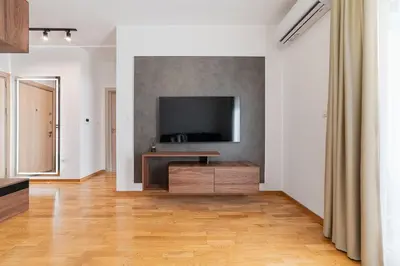 a living room with a flat screen tv on a wall at Aurora 2 Apartment with Garage in Budva