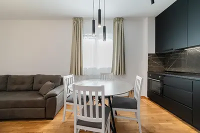 a kitchen and living room with a table and chairs at Aurora 2 Apartment with Garage in Budva