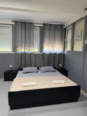 a bedroom with a bed with two towels on it at Petar Marstijepović in Bar, Susanj
