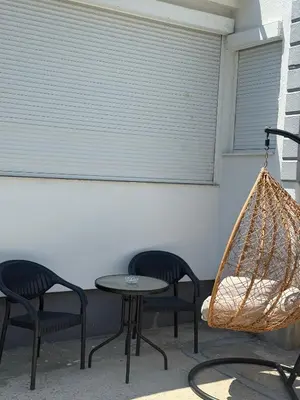 a patio with two chairs and a table and a hammock at Petar Marstijepović in Bar, Susanj