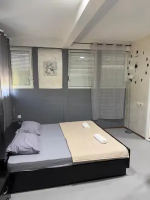 a bedroom with a bed with two towels on it at Petar Marstijepović in Bar, Susanj