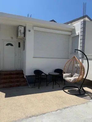 a patio with chairs and a swing and a building at Petar Marstijepović in Bar, Susanj