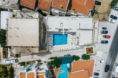 an overhead view of a building with a swimming pool at Lotos - stan 310 in Dobra Voda