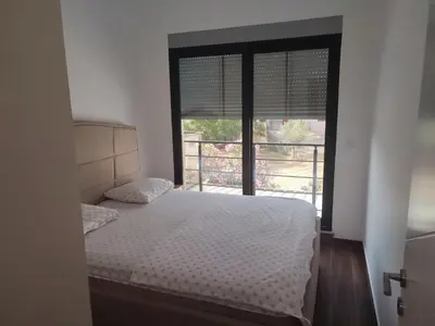 a bedroom with a bed and a large window at Premium 2 Dobra Voda in Dobra Voda