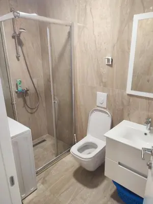 a bathroom with a shower and a toilet and a sink at Premium 2 Dobra Voda in Dobra Voda
