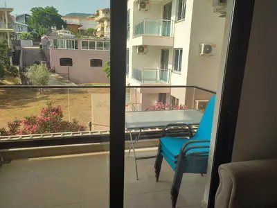 a balcony with a table and chairs and a window at Premium 2 Dobra Voda in Dobra Voda