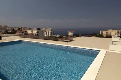 a swimming pool on the roof of a building at Premium 2 Dobra Voda in Dobra Voda