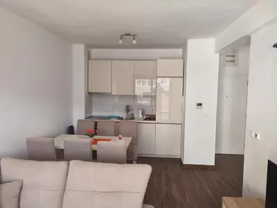a living room and kitchen with a couch and a table at Premium 2 Dobra Voda in Dobra Voda