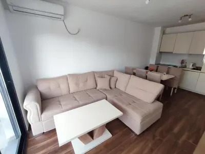 a living room with a white couch and a table at Premium 2 Dobra Voda in Dobra Voda
