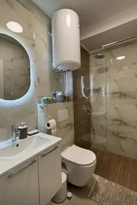 a bathroom with a toilet and a sink and a shower at Bienvenue chez nous studio in Ulcinj