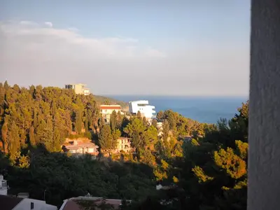 a town on top of a hill with trees at Bienvenue chez nous studio in Ulcinj
