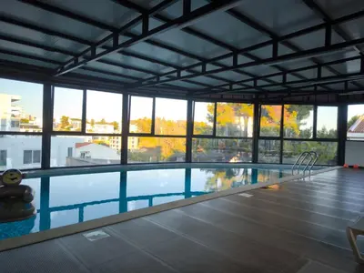 a large swimming pool with a view of the city at Bienvenue chez nous studio in Ulcinj