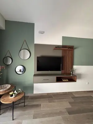 a living room with a flat screen tv on a wall at Bienvenue chez nous studio in Ulcinj