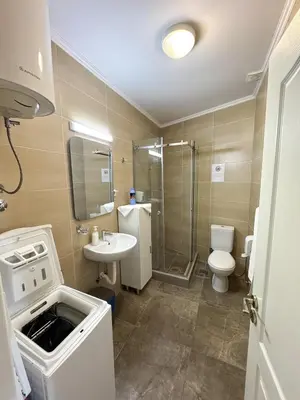 a bathroom with a sink and a toilet and a shower at Apartments First Line in Petrovac na Moru