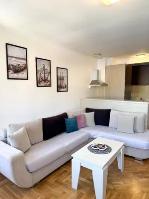 a living room with a couch and a table at Apartments First Line in Petrovac na Moru