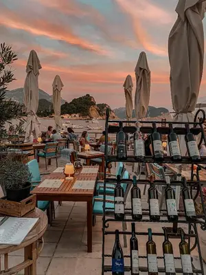 a bunch of bottles of wine on a patio at Apartments First Line in Petrovac na Moru