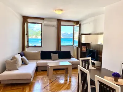 a living room with a couch and a table at Apartments First Line in Petrovac na Moru