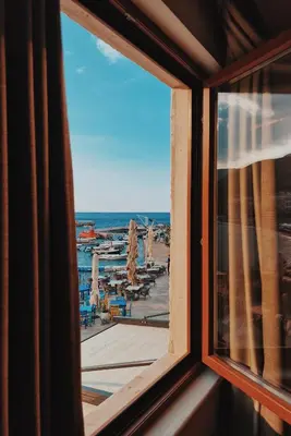 a view of a beach from a window at Apartments First Line in Petrovac na Moru