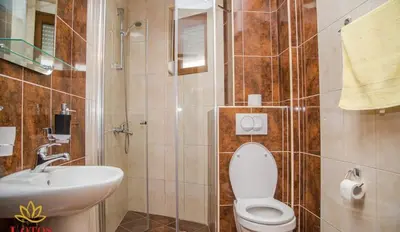 a bathroom with a toilet and a sink at Lotos - stan 318 in Dobra Voda
