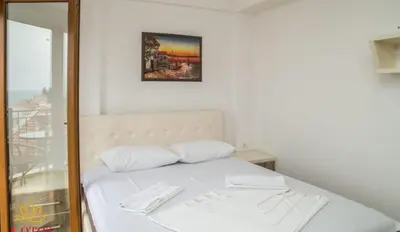 a bed with two white pillows in a room at Lotos - stan 423 in Dobra Voda
