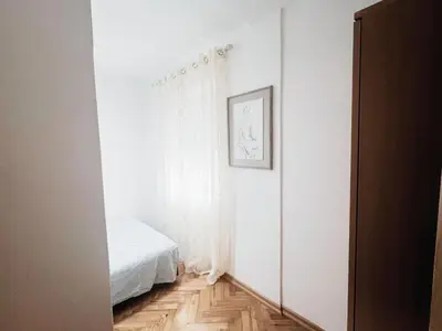 a white room with a bed and a mirror at Lalic House Budva in Budva