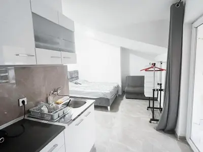 a kitchen with a sink and a bed in a room at Lalic House Budva in Budva