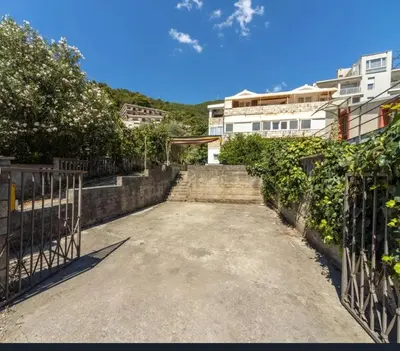 a driveway with a fence and a frisbee at Lalic House Budva in Budva