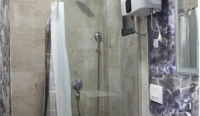 a bathroom with a shower with a glass door at Lotos - stan 106 in Dobra Voda