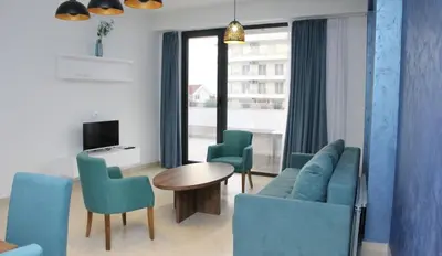 a living room with a couch and chairs and a table at Lotos - stan 106 in Dobra Voda