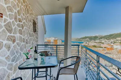 a table and chairs on a balcony with a view at Lotos - stan 106 in Dobra Voda