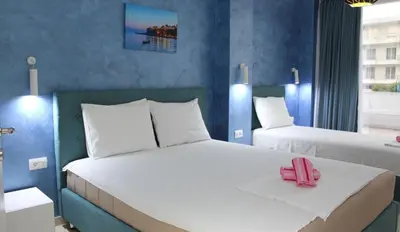 a bedroom with two beds and a pink phone on the bed at Lotos - stan 106 in Dobra Voda