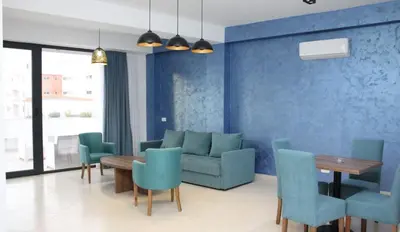 a living room with a couch and a table and chairs at Lotos - stan 106 in Dobra Voda