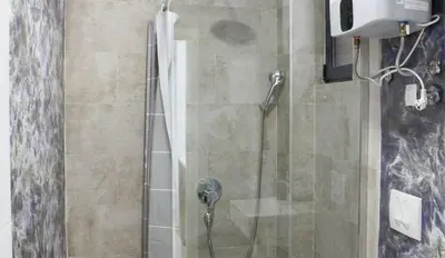 a bathroom with a shower with a glass door at Lotos - stan 212 in Dobra Voda
