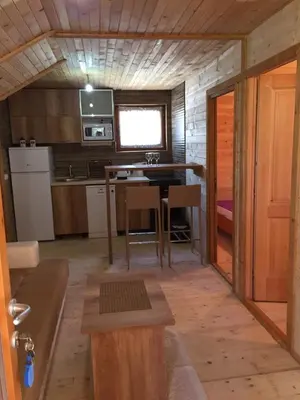 a small kitchen with a table in a tiny house at Nana Dea in Utjeha